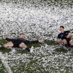 New Zealand All Blacks’ Cory Jane and Israel Dagg make “snow angels” in confetti as they celebrate beating France to win the Rugby World Cup final at Eden Park in Auckland