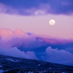 The super moon rises over a sunset sky at Falls Creek.