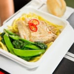 Barramundi poached in a lightly spiced coconut sauce with noodles, sugar snaps, choy sum and chilli