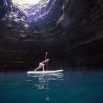 stand up paddleboard yoga in the crater