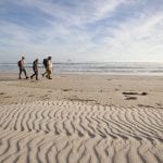 Hikers on Stephens Bay beach outside Port Davey.